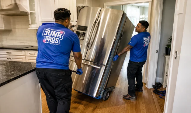 Murfreesboro Junk Removal Team Lifting a Heavy refrigerator